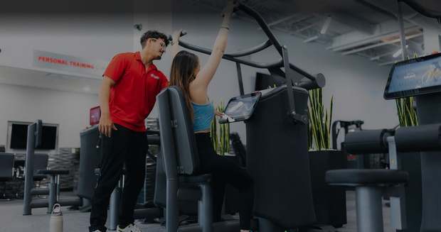 A certified personal trainer coaching a member at Workout Anytime